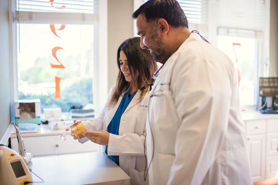 Dr. Shaikh and Dr. Vaid working together at a treatment station